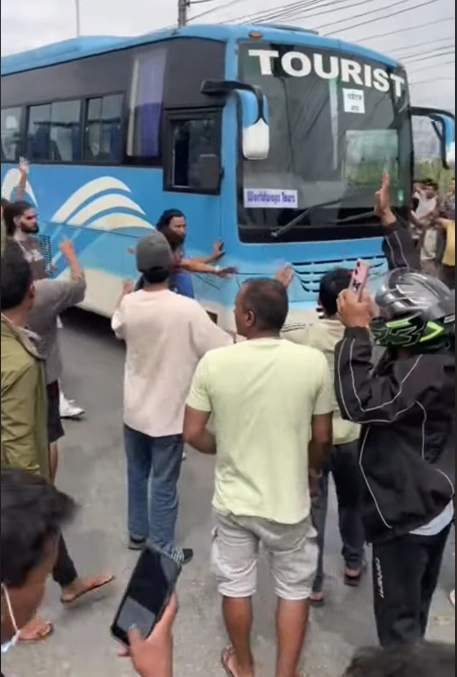 Is It Safe to Travel to Nepal After the September 2025 Protests? 5 protester-waving-tourist-bus